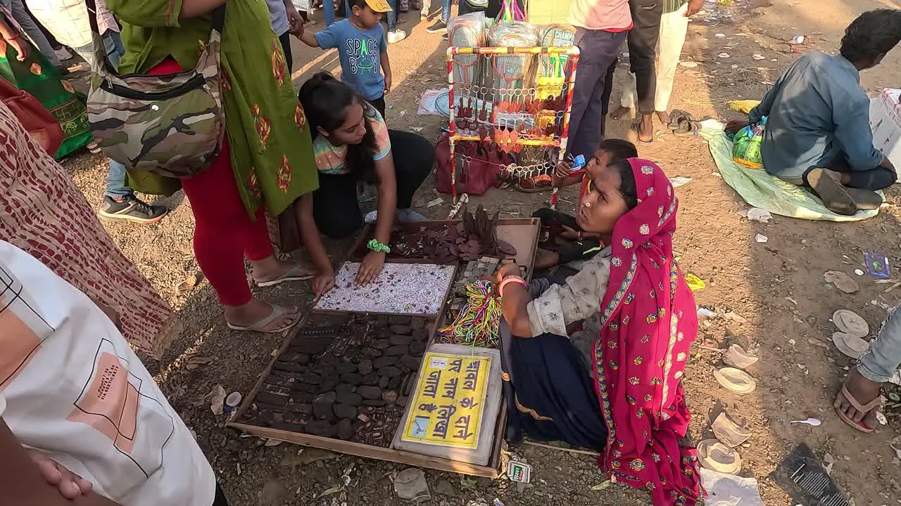 A woman is buying a kitchen set with an alphabetic ABCD puzzle from a fair