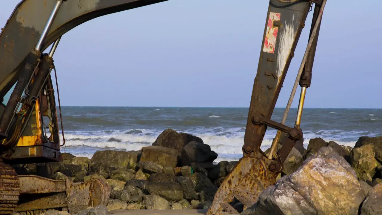 Abandoned Digger on Rocky Beach in Thailand