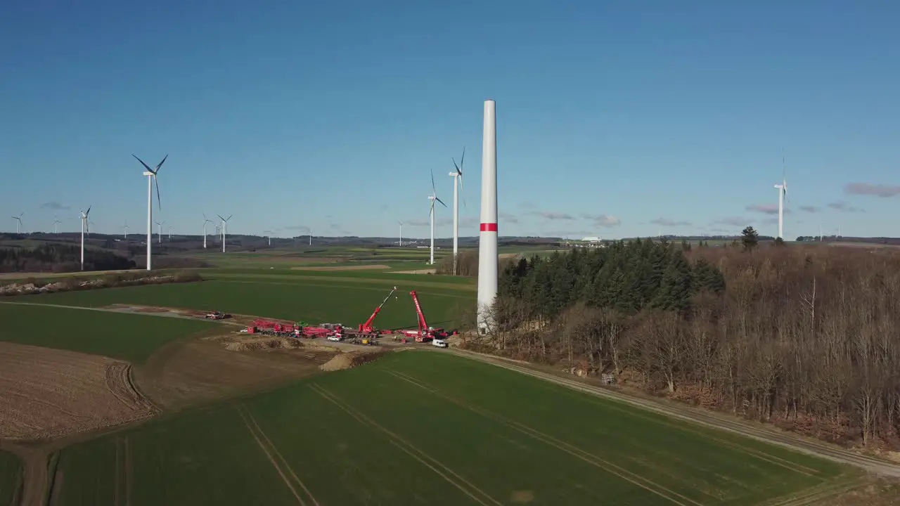 Construction Site Of A Wind Turbine Green Energy Generation aerial drone shot push in