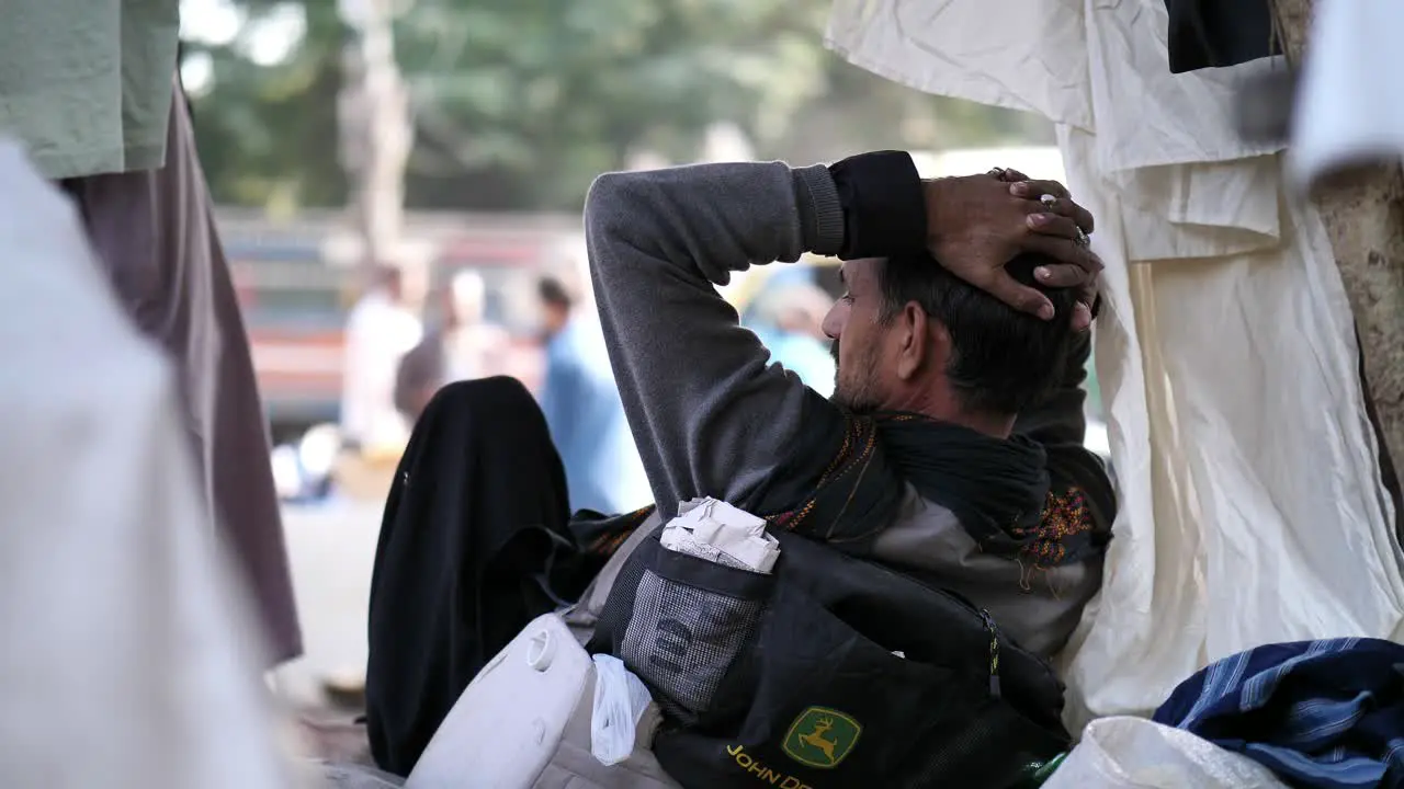 Sales man wearing casual dress hat selling at saddar bazar karachi Pakistan