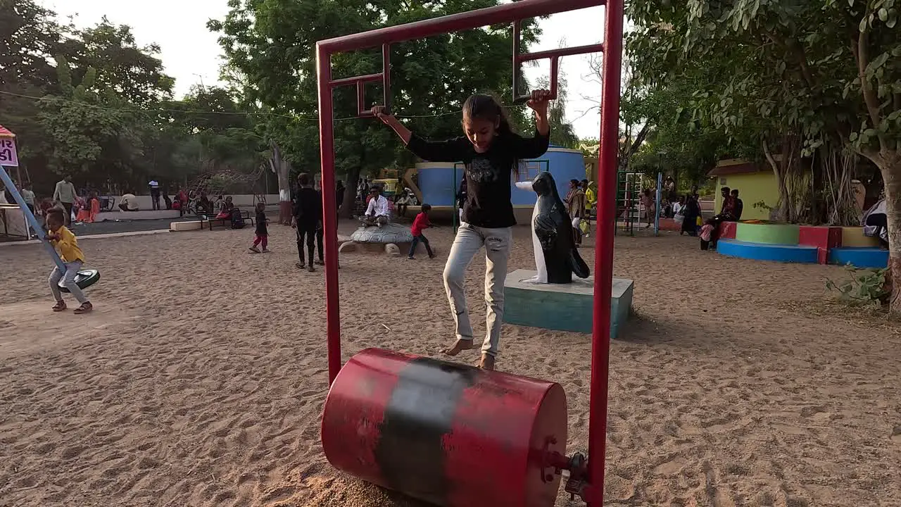 A little girl is running fast on a treadmill in a park