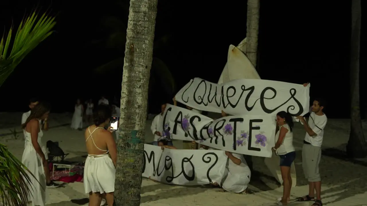 Young Couple Marriage Proposal At the Beach At Night with Friends San Andres Colombia