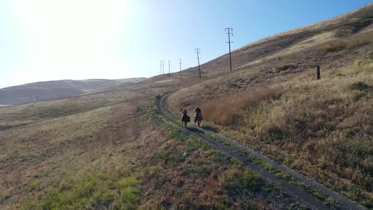 Beautiful Aerial Of Retired Retirement Couple Riding Horses Horseback On A Mountain Ranch In Santa Barbara California