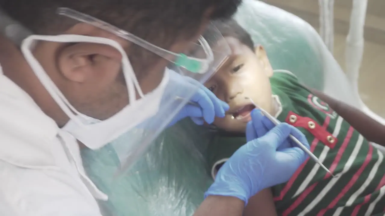 Dentist at work operating on a children