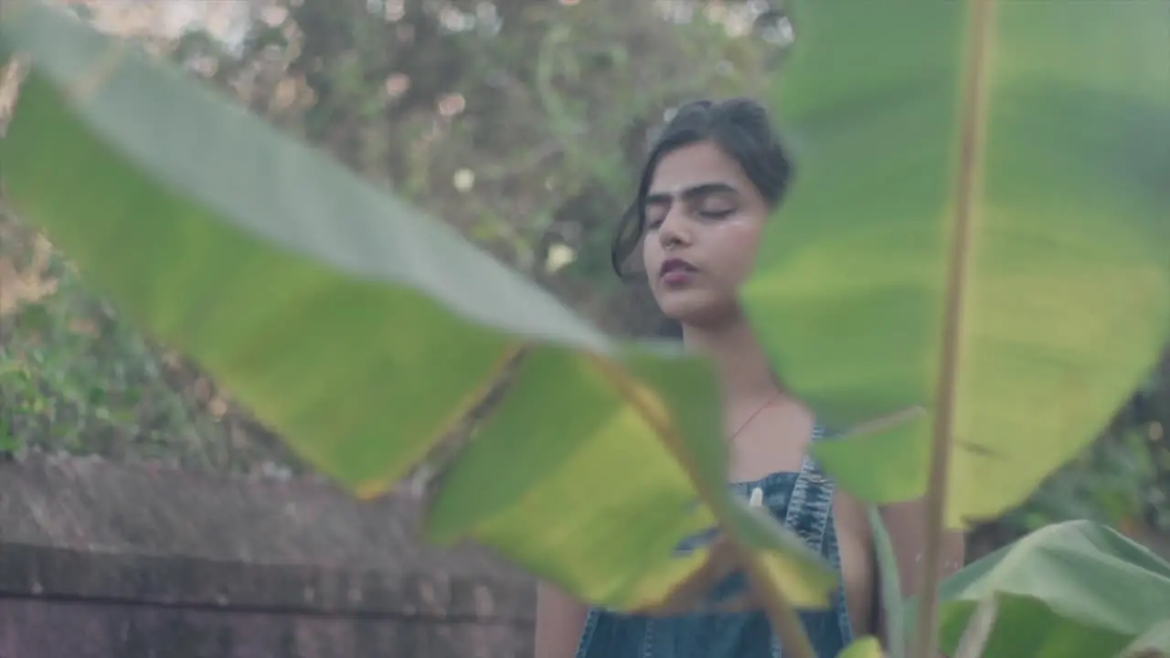 Beautiful Asian girl focusing meditating in the nature