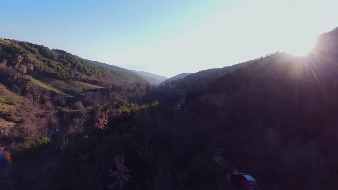 Areal footage of off road rally car driving on foothills at high speed