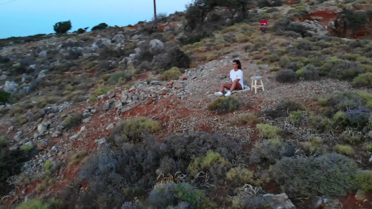 Caucasian Female drinking water with beautiful sunset