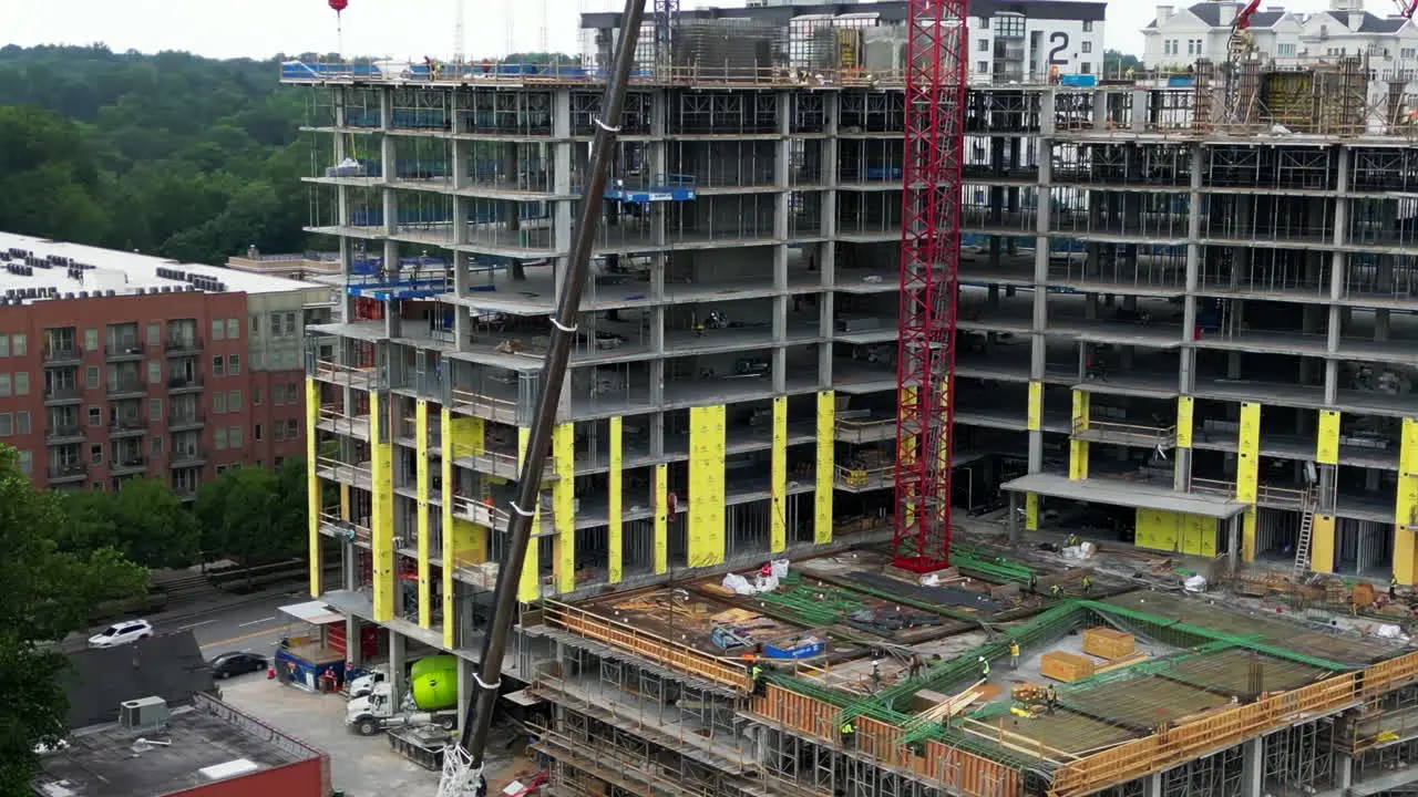 Workers and machinery on construction site of new building