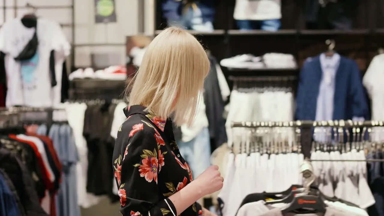 Young woman during big shopping in the clothes store