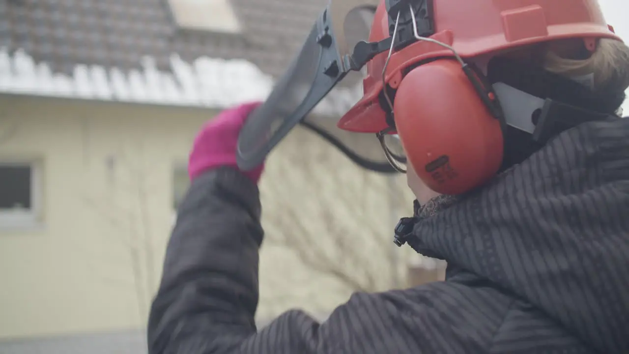 Close up shot of a female wearing a hard helmet with visor for protection