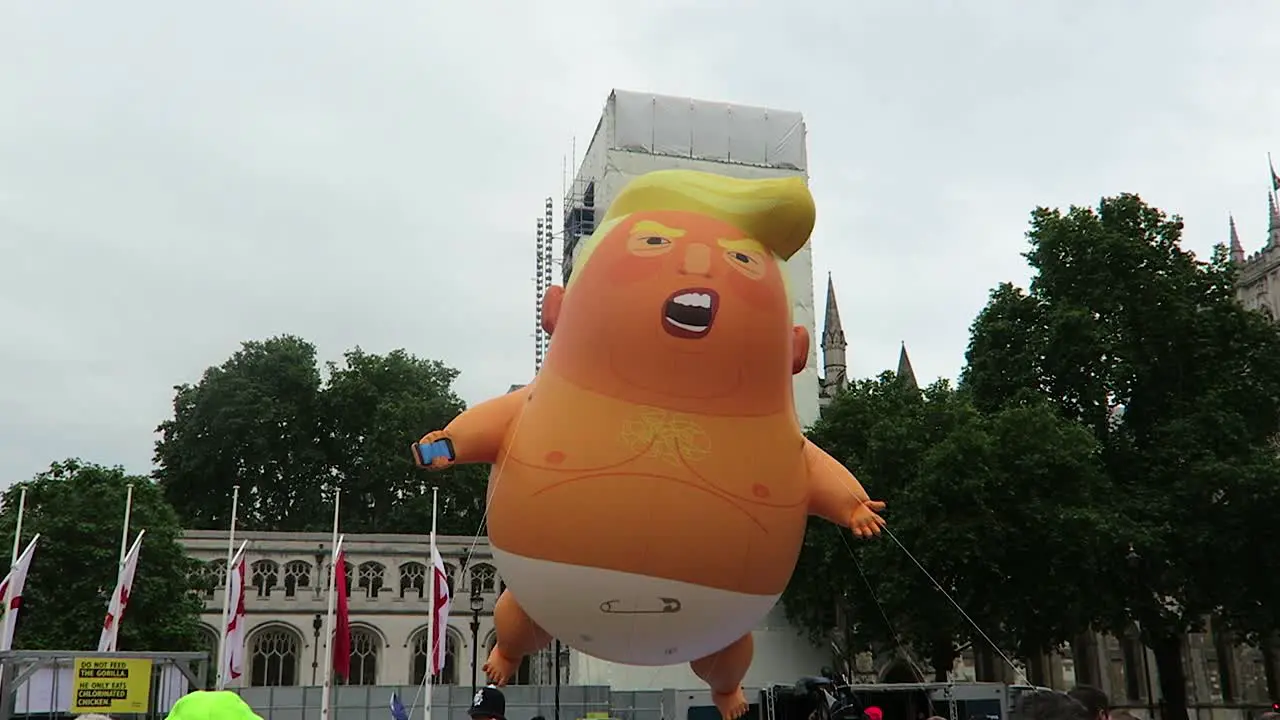 Crowds of people gathered to see the Baby Trump Balloon at Parliament Square Garden on day President Donald Trump visit to UK on 4th June 2019