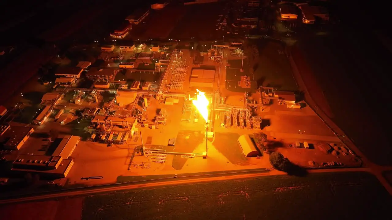 The Entire Facility is Bathed in Light as Gas Flaring Occurs Drone Orbit Shot