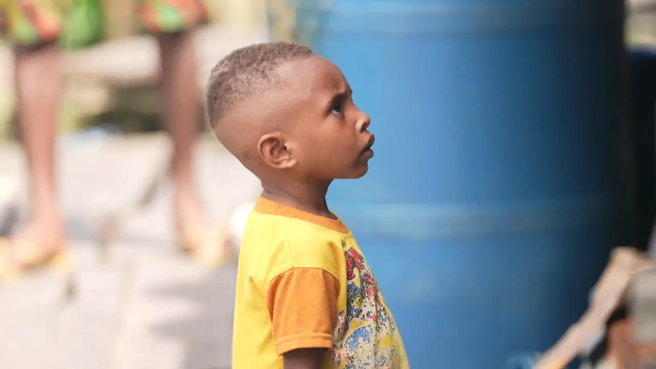 A Papuan child wearing a yellow shirt and a teenager wearing a black shirt will play in the Indonesian Papuan Asmat