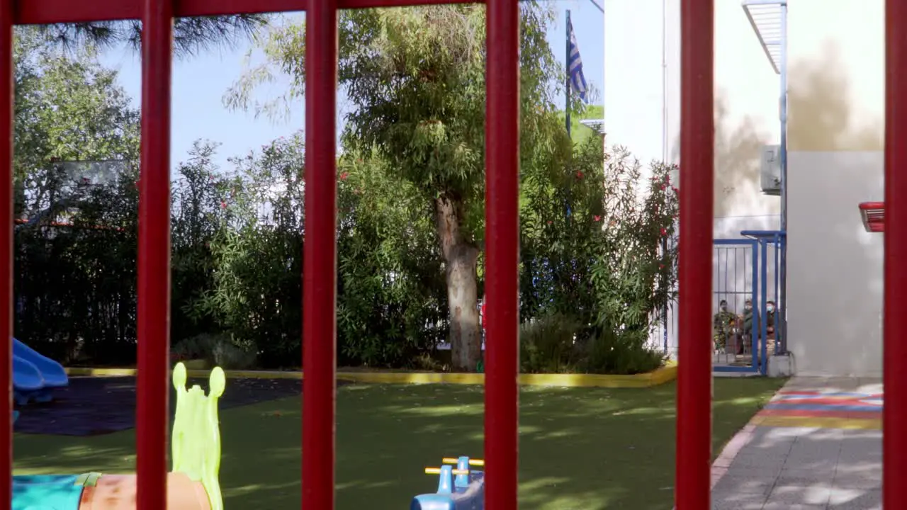 Footage behind bars of primary school of Kifissia Athens Greece while students celebrating the national holiday of October 28th during coronavirus lockdown