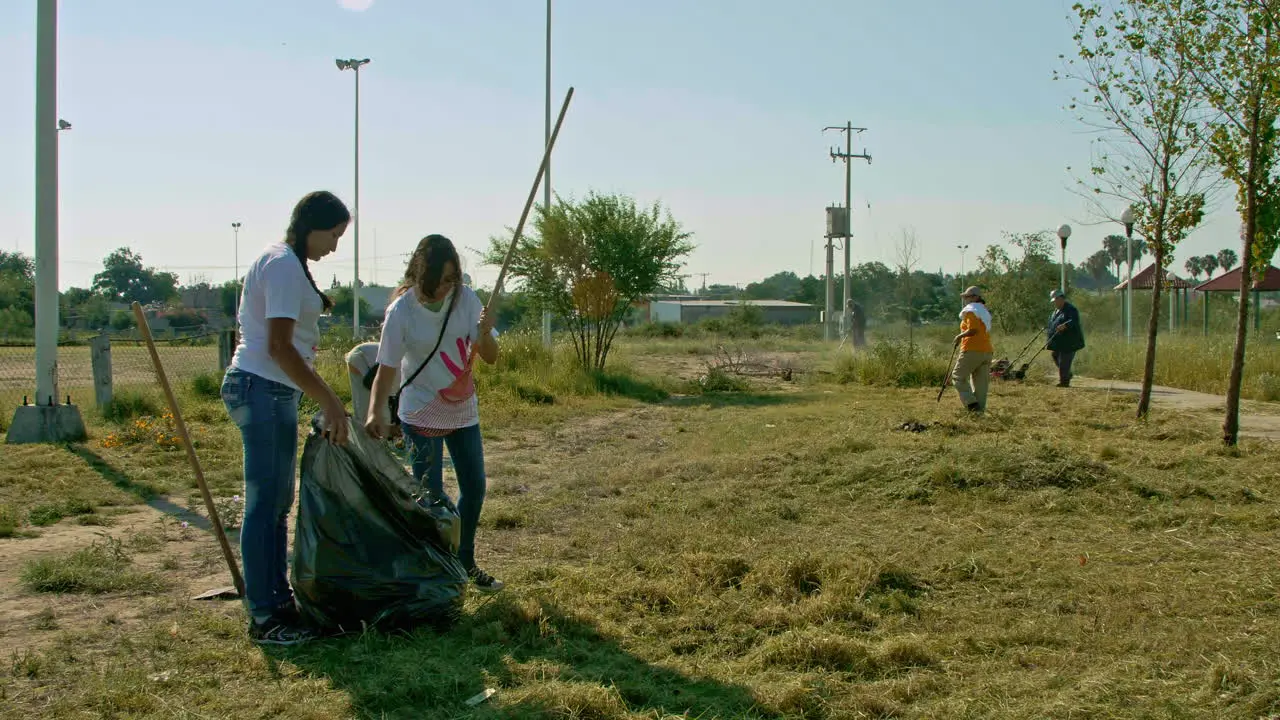 Group Of Volunteers Cleaning Up Park