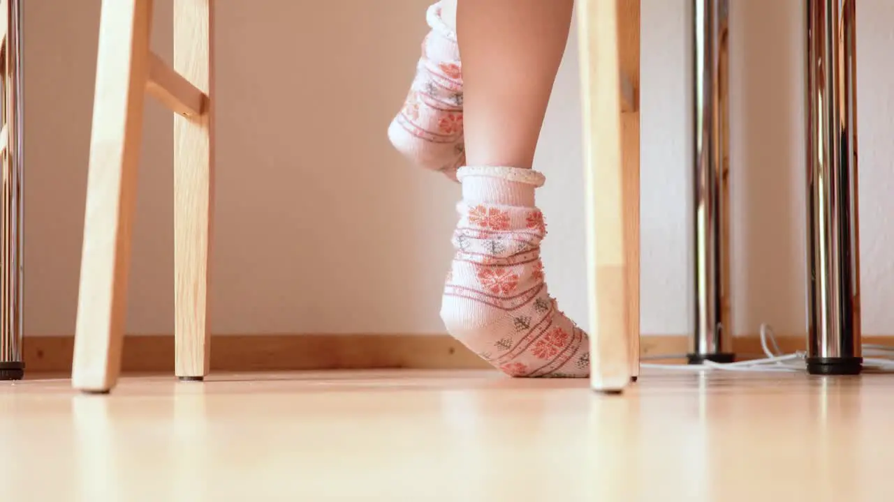 concentrated Feet jiggling under table in warm christmas socks