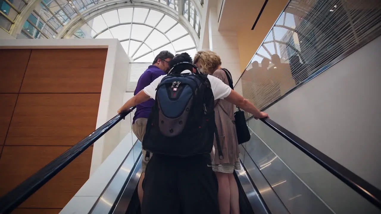 People riding an escalator in a shopping mall