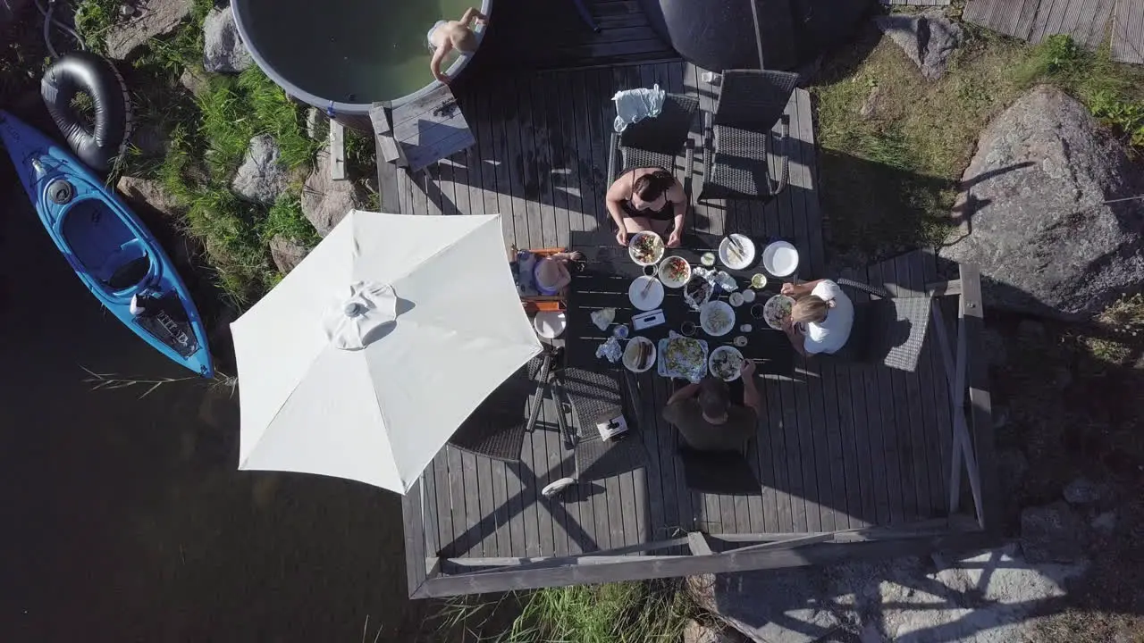 Summer vacation in Scandinavia aerial top down view of People eating at Nordic cabin