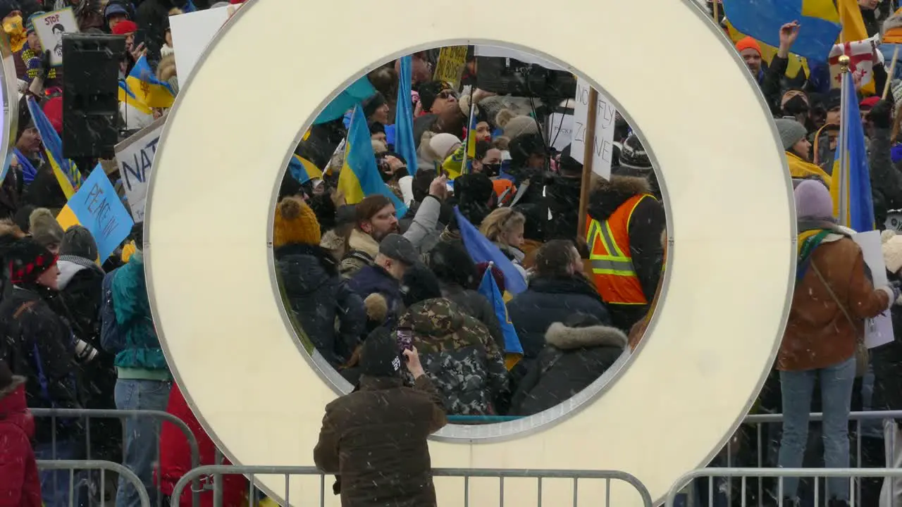 Crowd show anti-war support for Ukraine under snowfall light Toronto