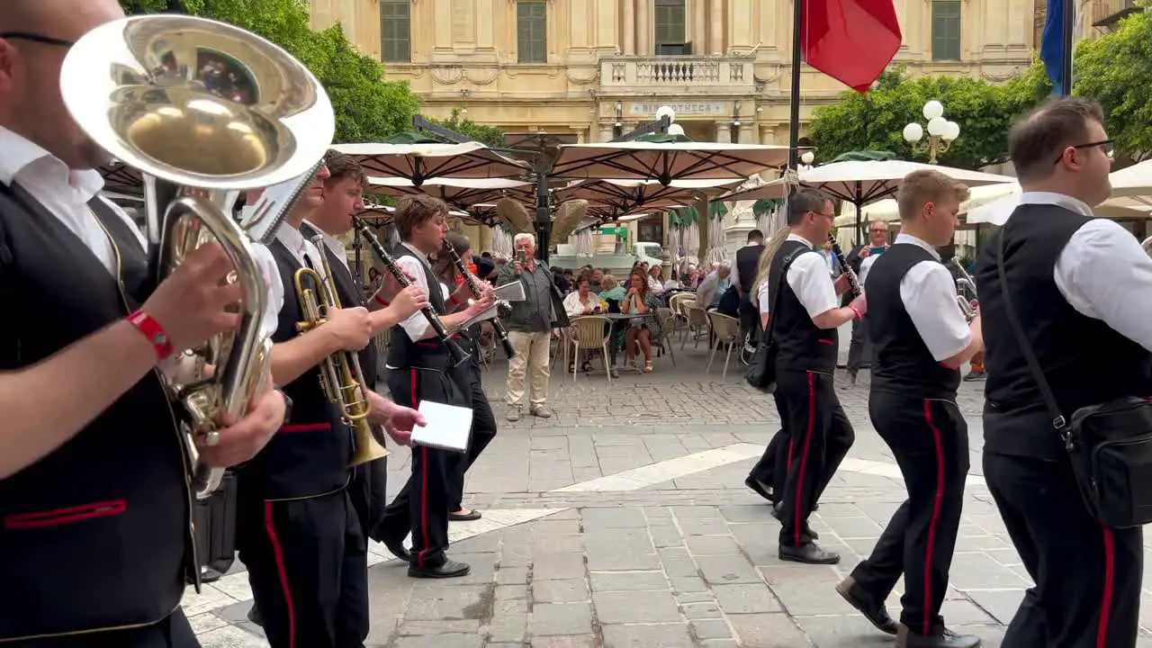 A music parade with people watching in the background in Valetta