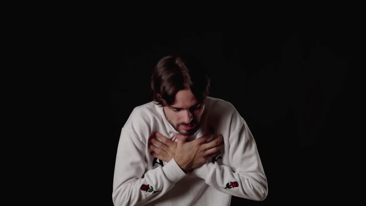 Trendy Young Man scared gesture frightened expression wide black background