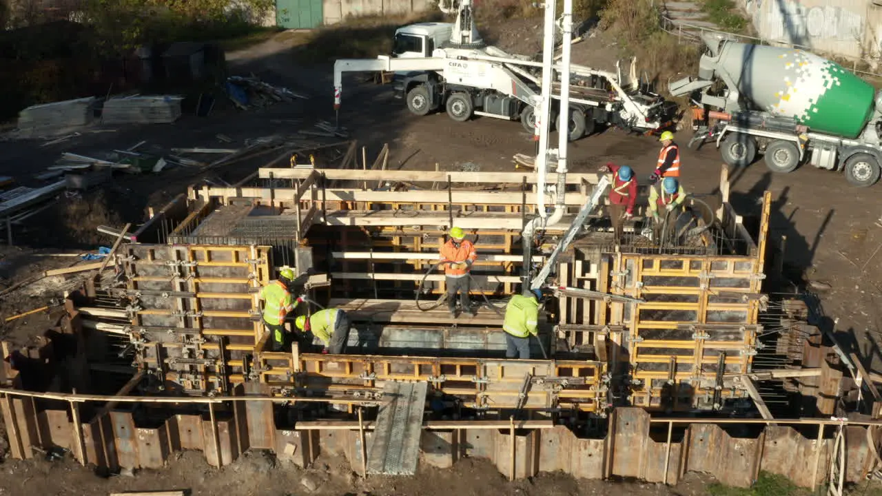 Construction workers working on formwork made of wood and steel