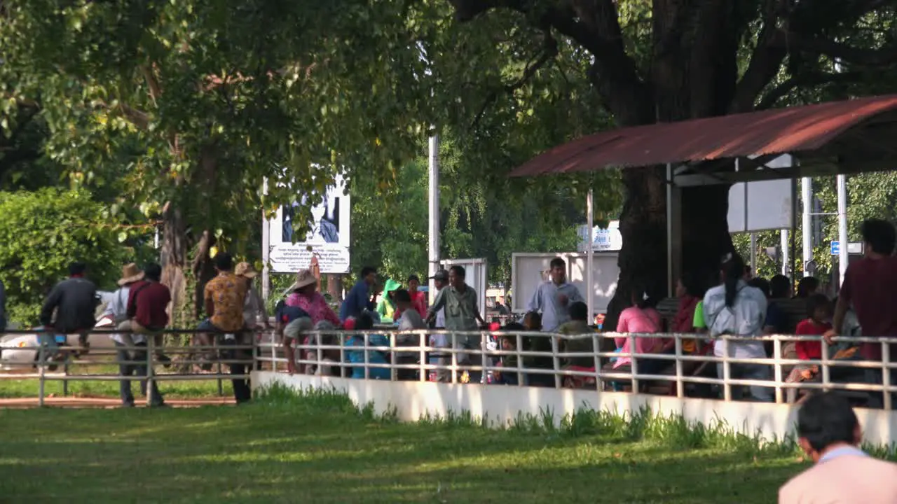 People Waiting Outside the Hospital Under a Tree