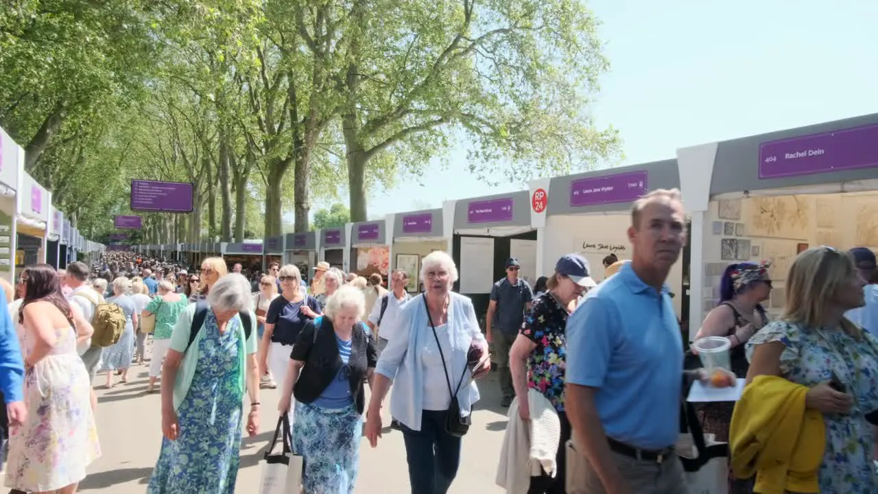 Crowds of people walking down the shopping promenade at the Chelsea flower show