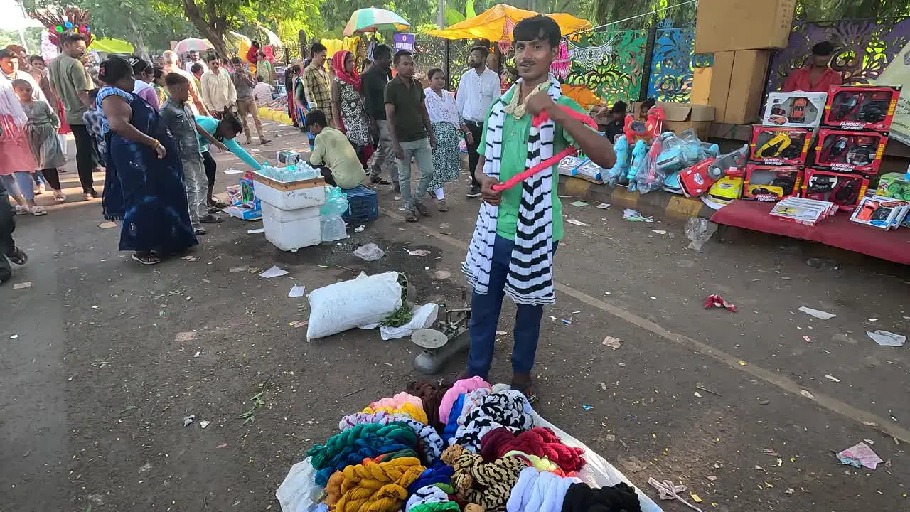 A shopkeeper is selling clothes on the road