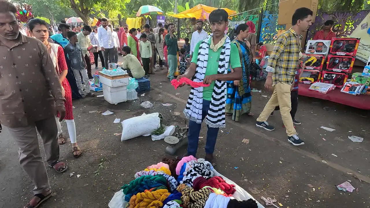 Scene from the front a shopkeeper selling clothes on the road