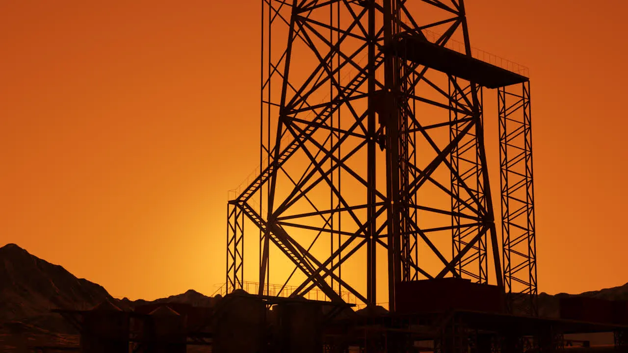 A big drill rig during sunrise on the oil field A metal construction used in the petrochemical industry Equipped with large drills the structure can drill oil wells or natural gas extraction wells