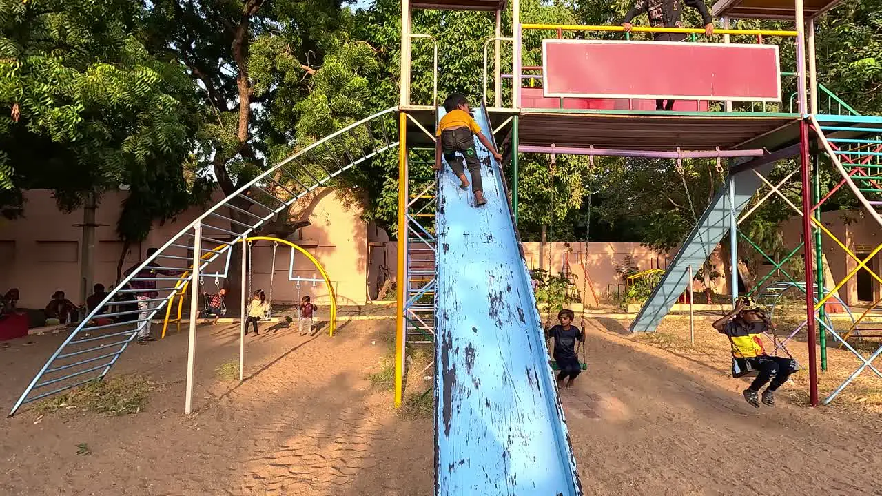 A young child shows off his talent by riding on the front of a sliding ride