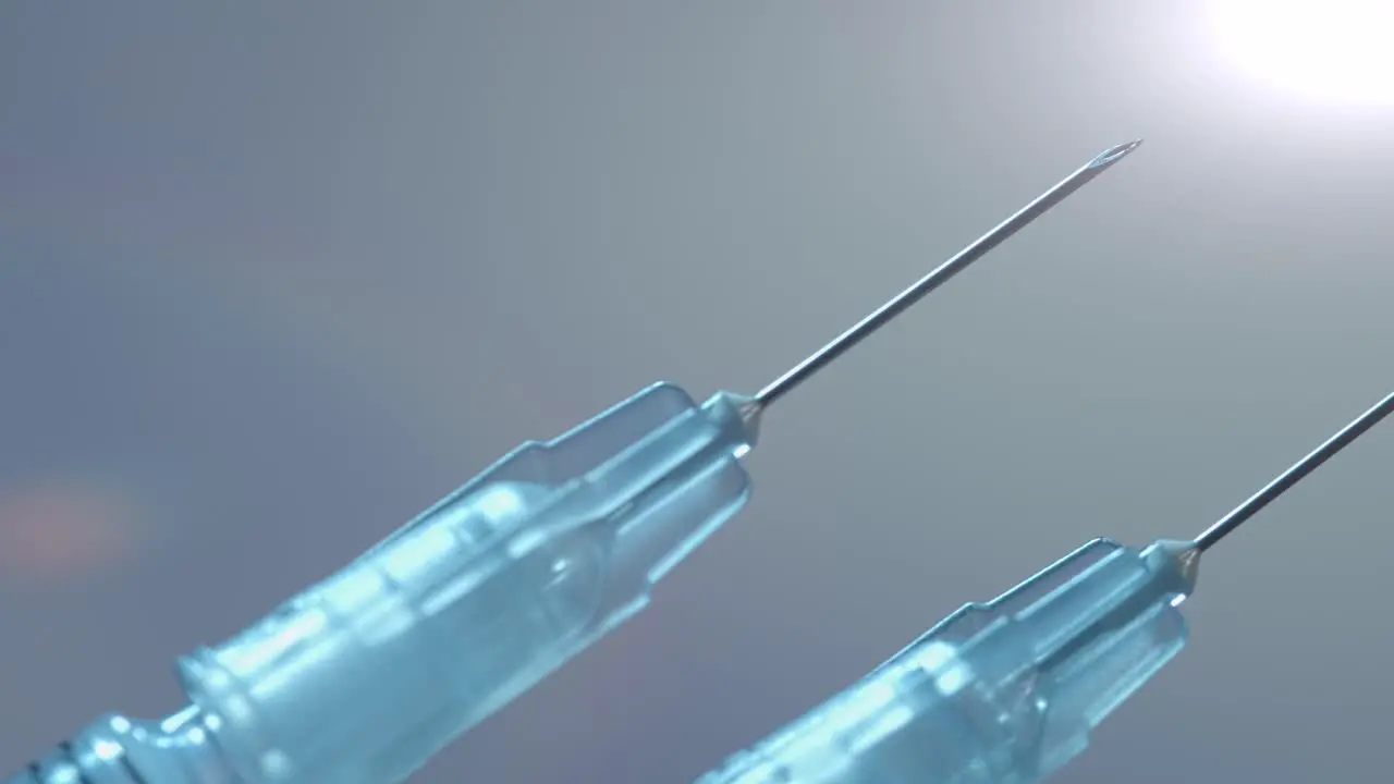 Two syringes for both doses of the Covid-19 vaccine close up sliding isolated