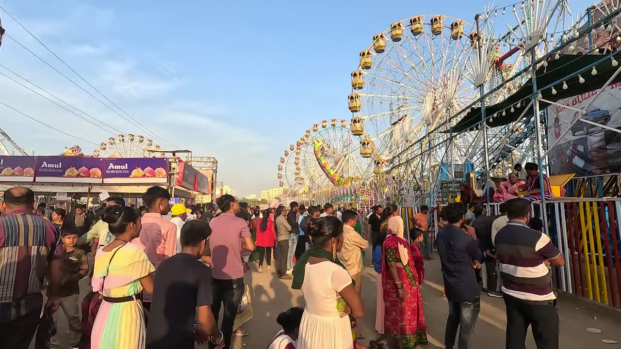 During the day people are queuing up to sit on the rides at the amusement park