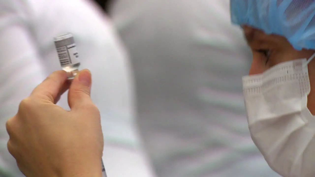 Nurse fill a syringe with one dose of the COVID vaccine isolated