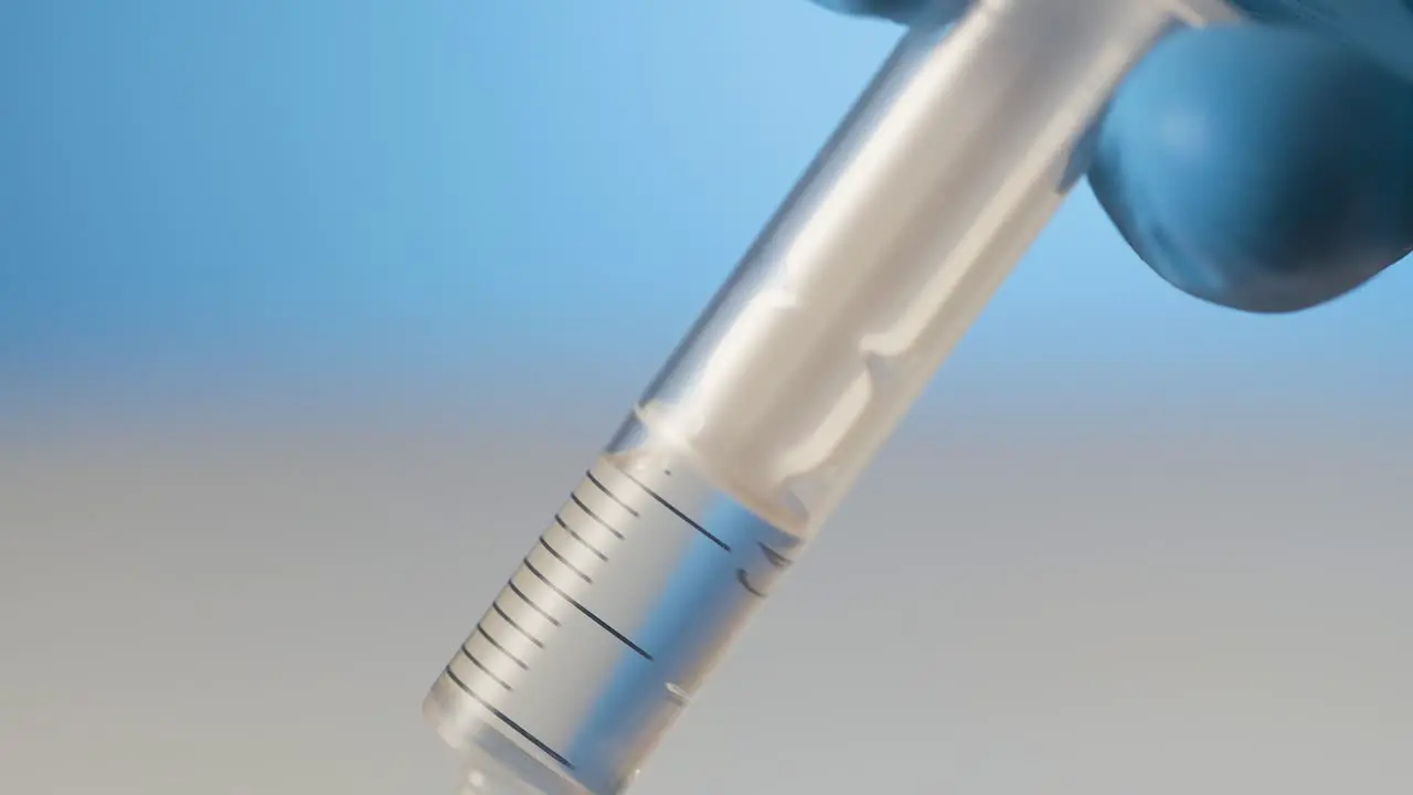 Extreme close-up liquid in syringe injection needle concept getting a shot