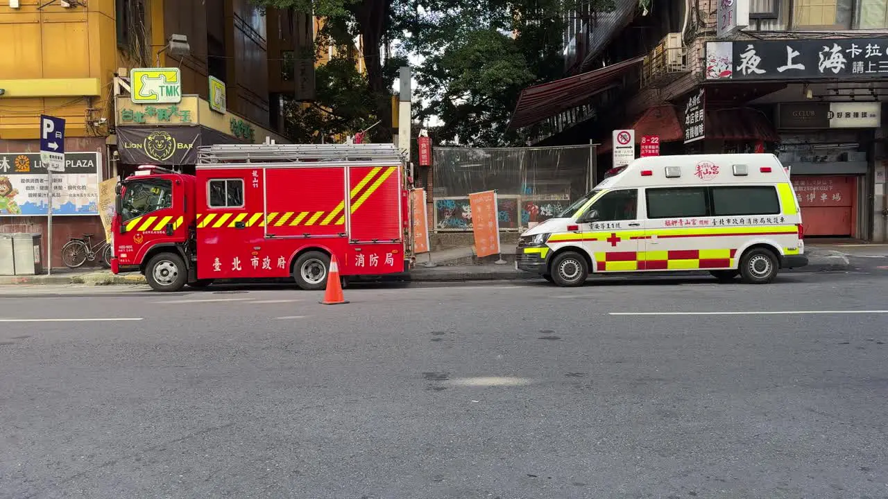 Direct frontal view of an ambulance and fire truck are on standby for a rescue in Taipei Wanhua district Ximending Taiwan