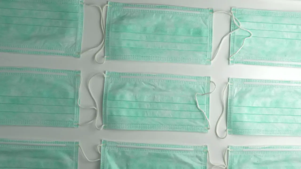 Disposable Face masks arranged in a pattern Rotating overhead shot