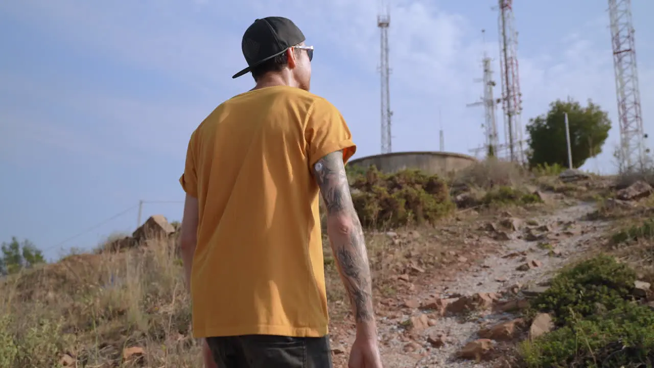 Young diabetic fit men hiking with blood sugar sensor on his arm