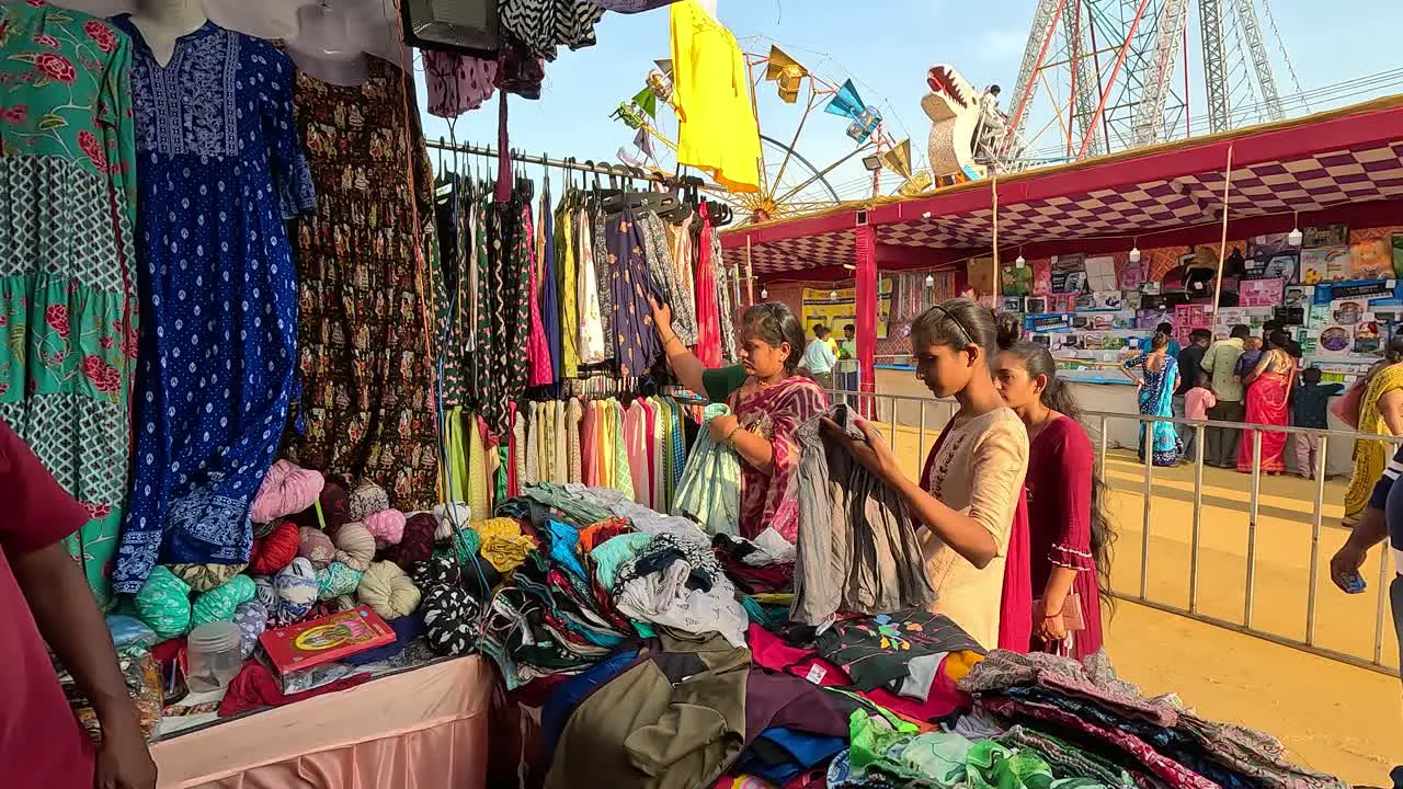 Clothing store scene women are buying clothes like ladies dresses and kurtis from the sale