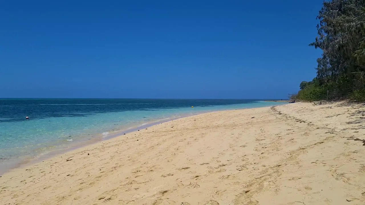 Slow Aerial Low Flying Over Sandy Beach On Green Island