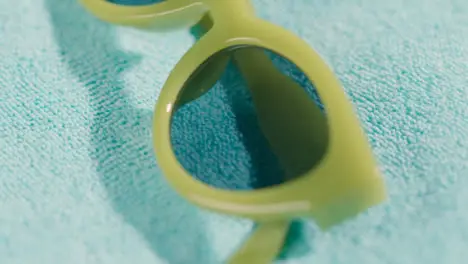 Close Up Summer Holiday Concept Of Green Sunglasses On Beach Towel 1