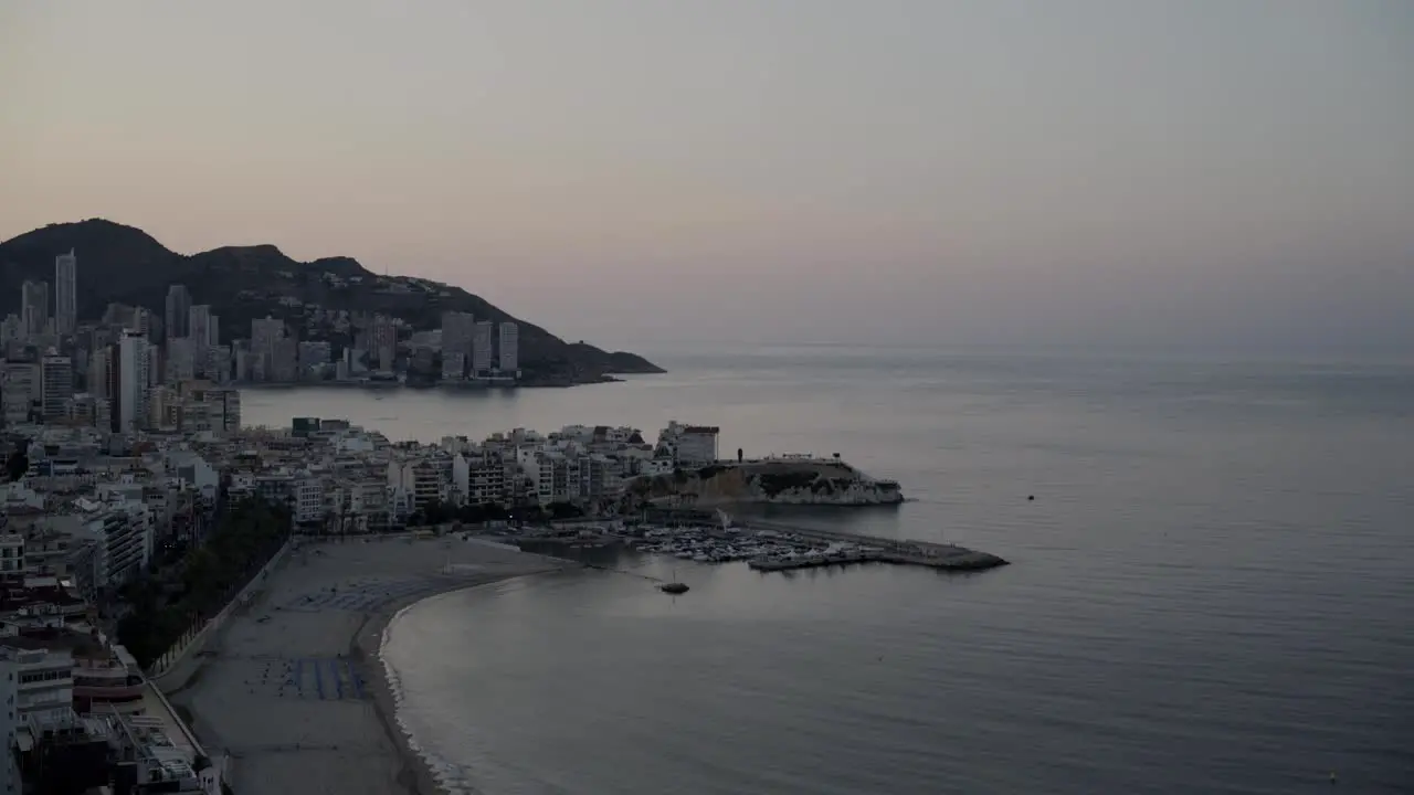 Mediterranean first light time lapse wide view Benidorm beach and coastline from above 4K