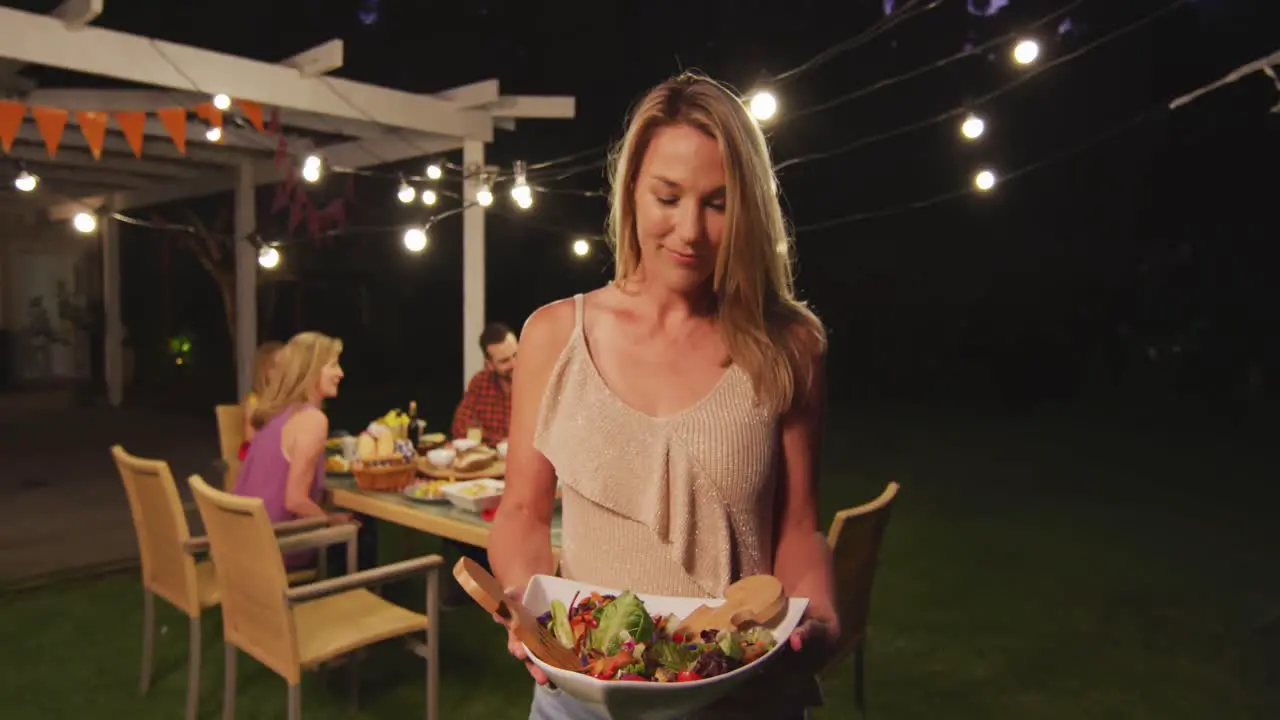 Young woman holding food tray outdoors