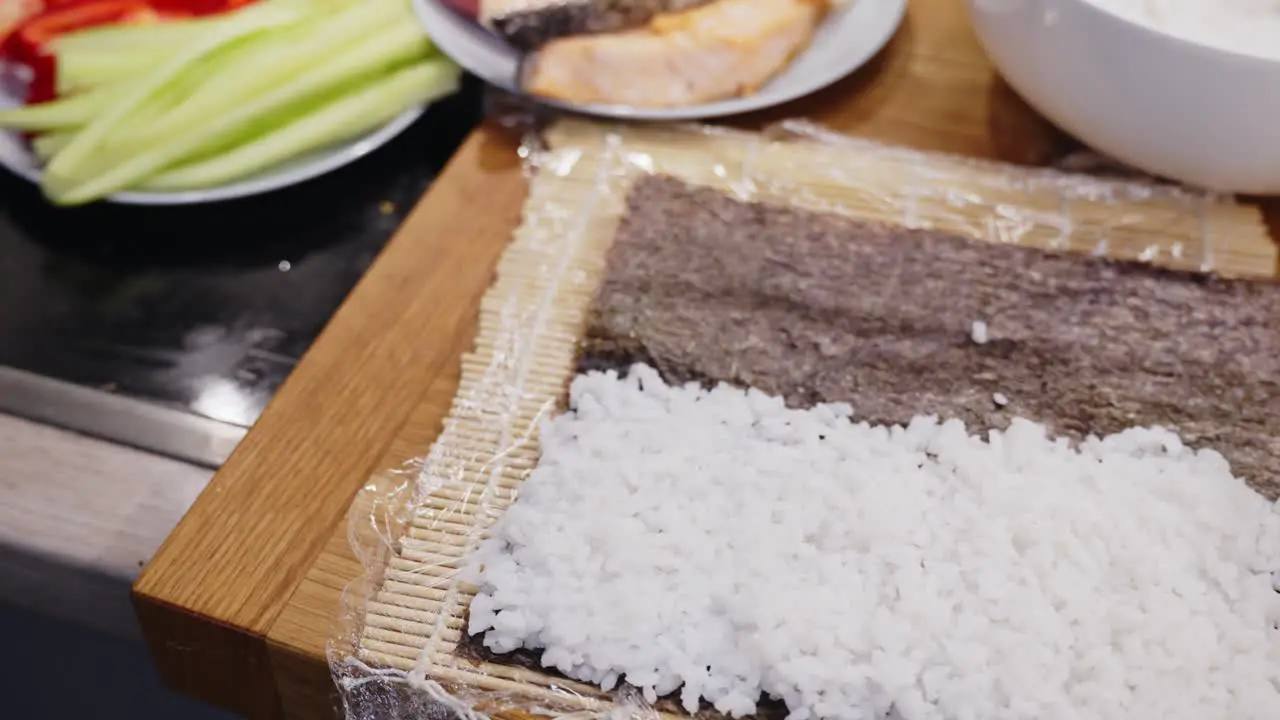 Zooming Out From White Rice On Wooden Mat Ready For Sushi Preparation