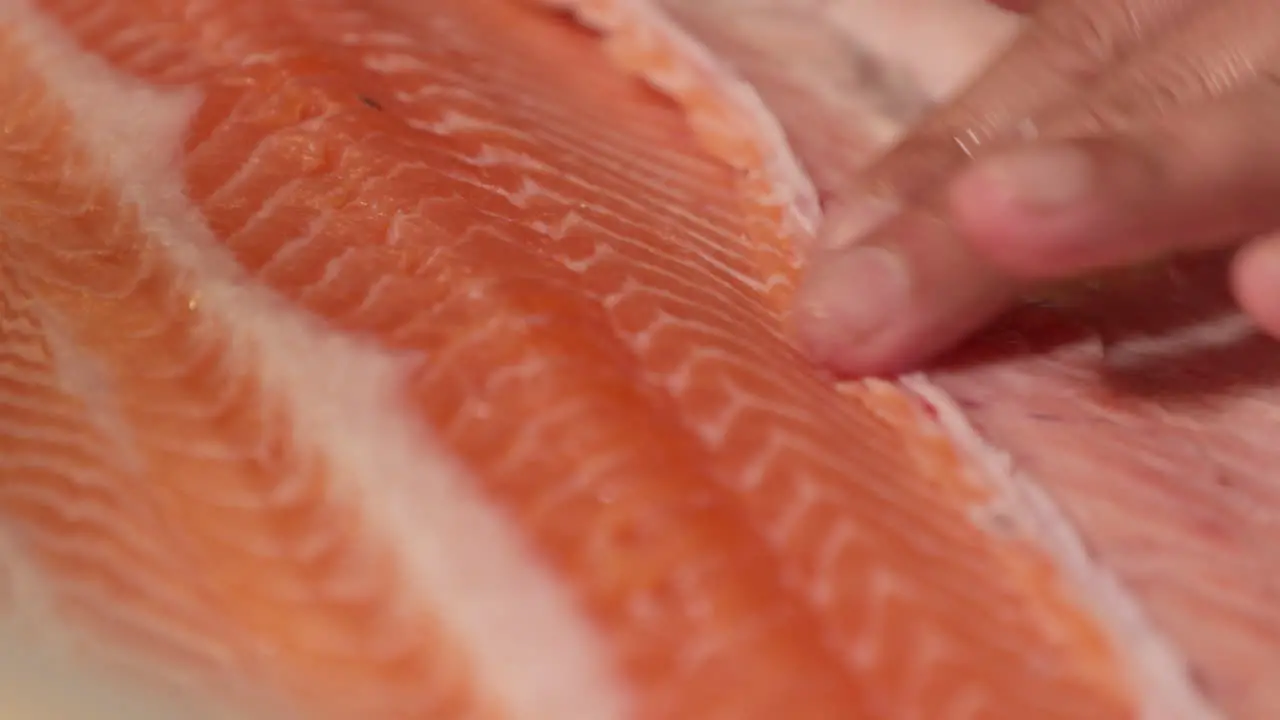 A Chef Trimming The Meat Of A Fresh Salmon Fillet Using A Sharp Knife For Sushi