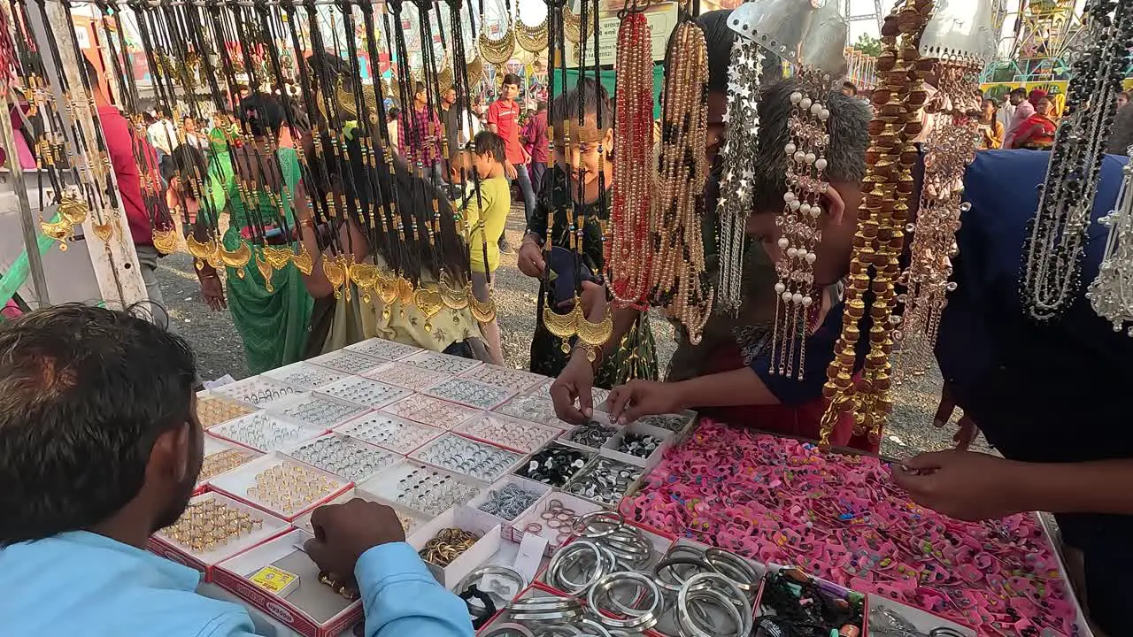 Many young boys and girls are buying silver and gold jewelery from the fair