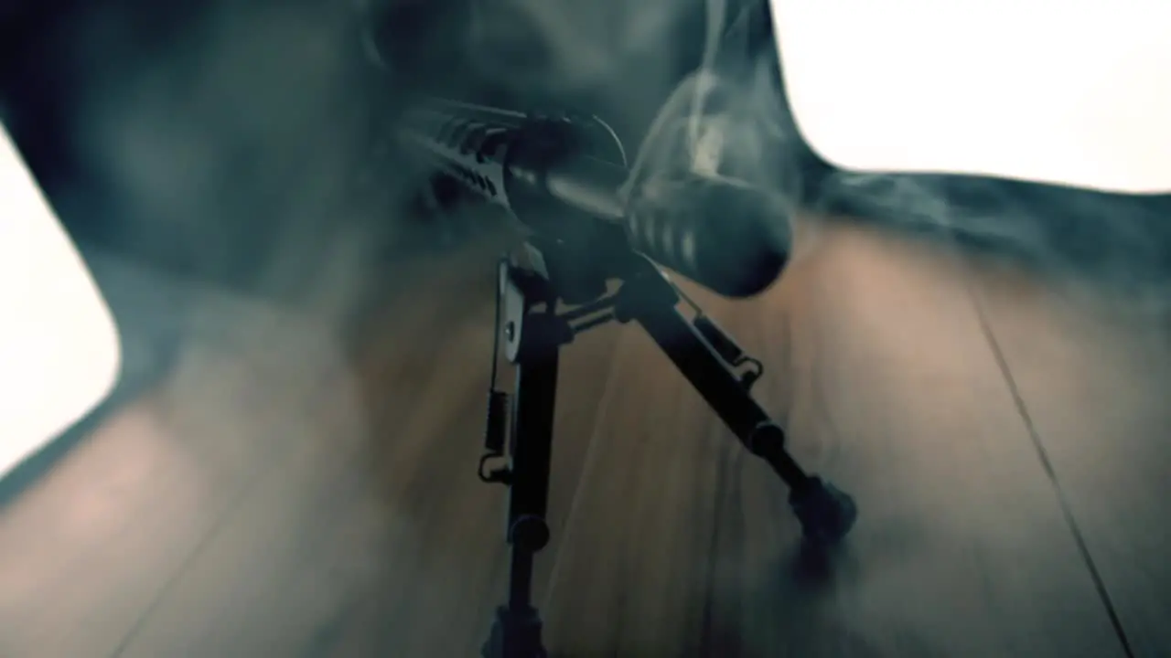 Assault rifle with smoke coming out of barrel in slowmotion