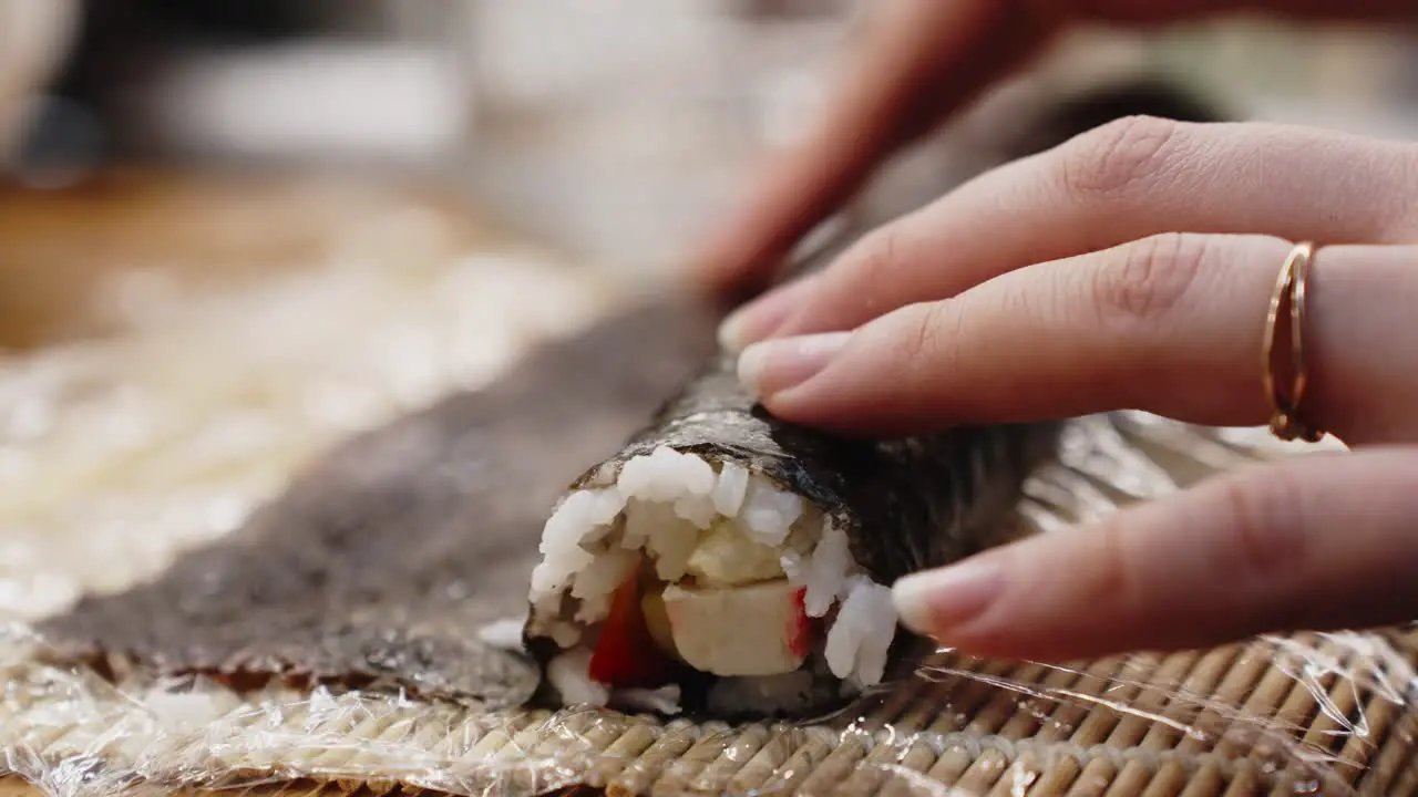 Girl Hand Holding Green Sushi Roll  Homemade Preparation