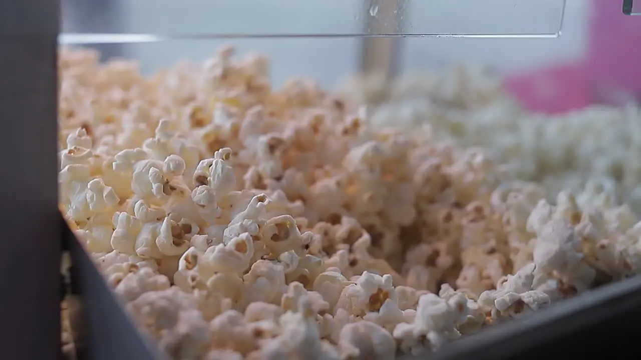 Piles of popcorn in display case Shot shot with dolls